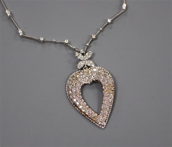 A modern 750 white metal and diamond set heart shaped pendant necklace, pendant 45mm.